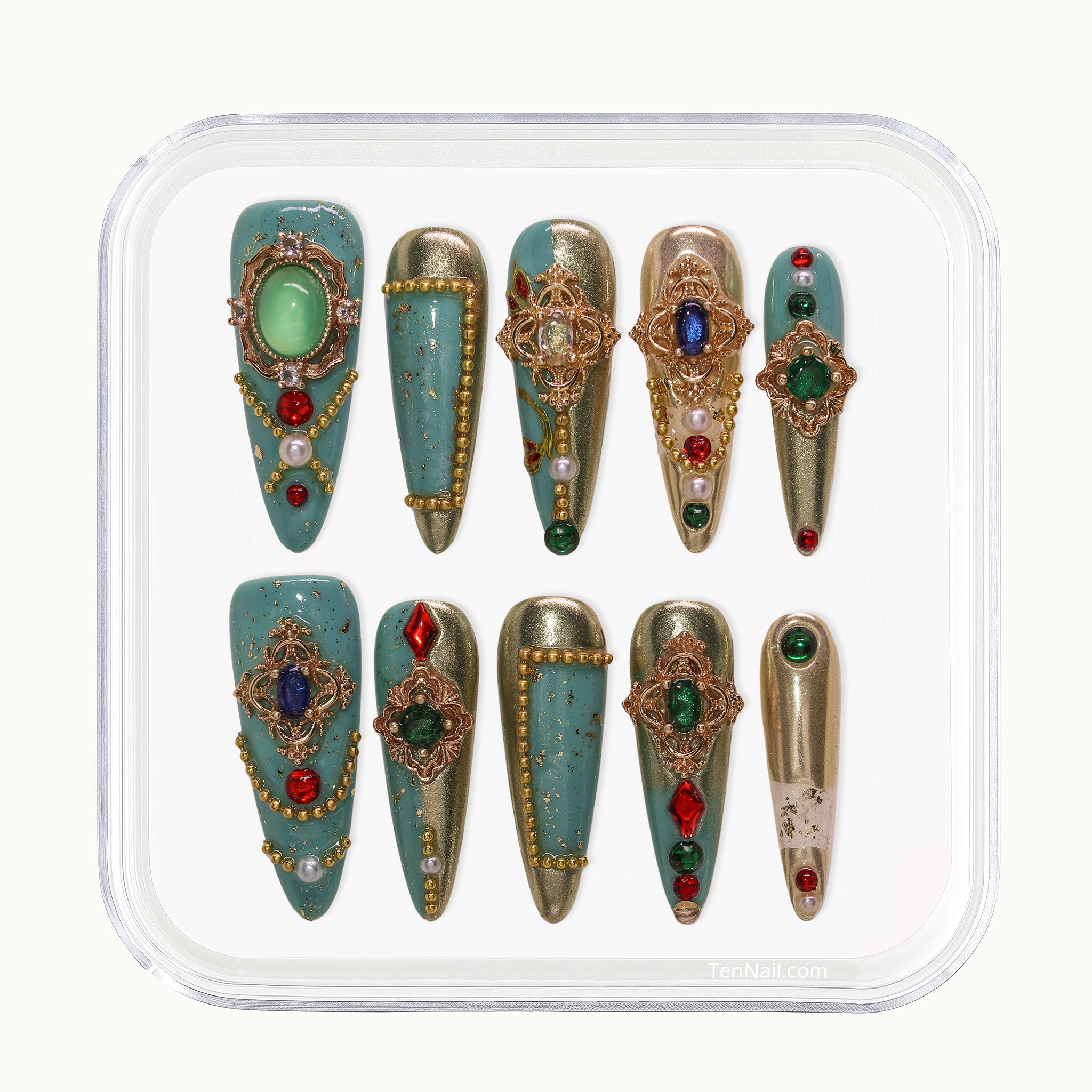 Long Stiletto press-on nails in turquoise and metallic gold with multi-colored rhinestones and pearls.